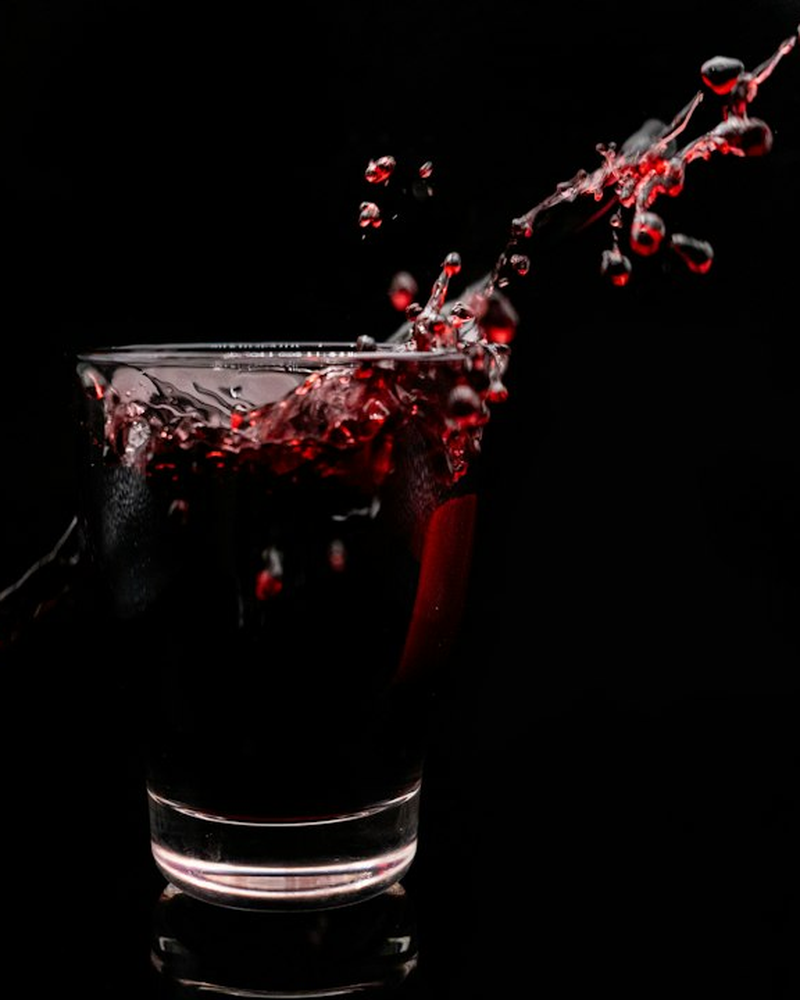 A bartender at PowerupDash pouring a cocktail into a chilled glass