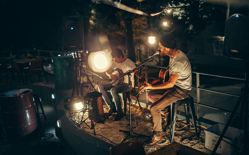 A duo performing an early-evening set on the small stage
