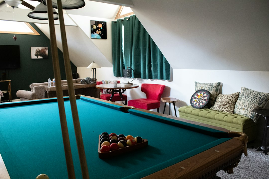 The quieter side lounge at PowerupDash with low seating, a pool table and warm lamp light
