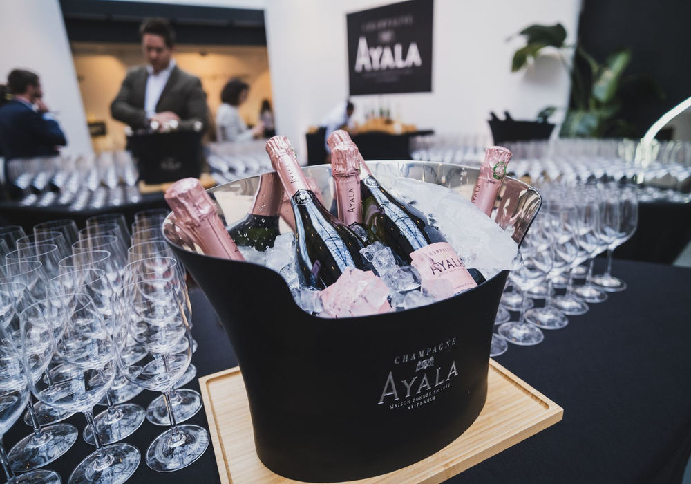Reserved booth with a bottle in an ice bucket, glassware and a velvet rope
